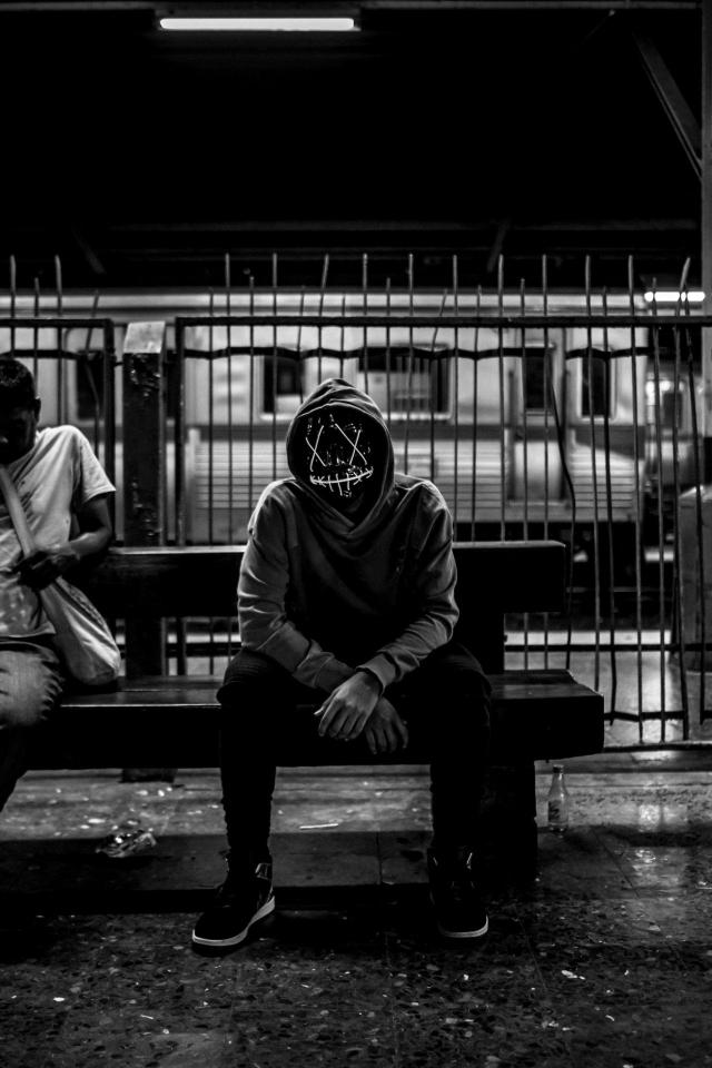 Masked Figure at Station