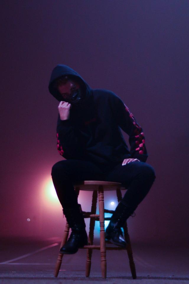 Masked Figure in Shadow