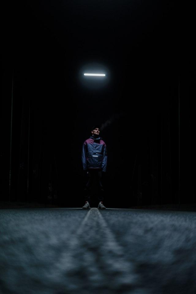 Solitary Figure Under Light