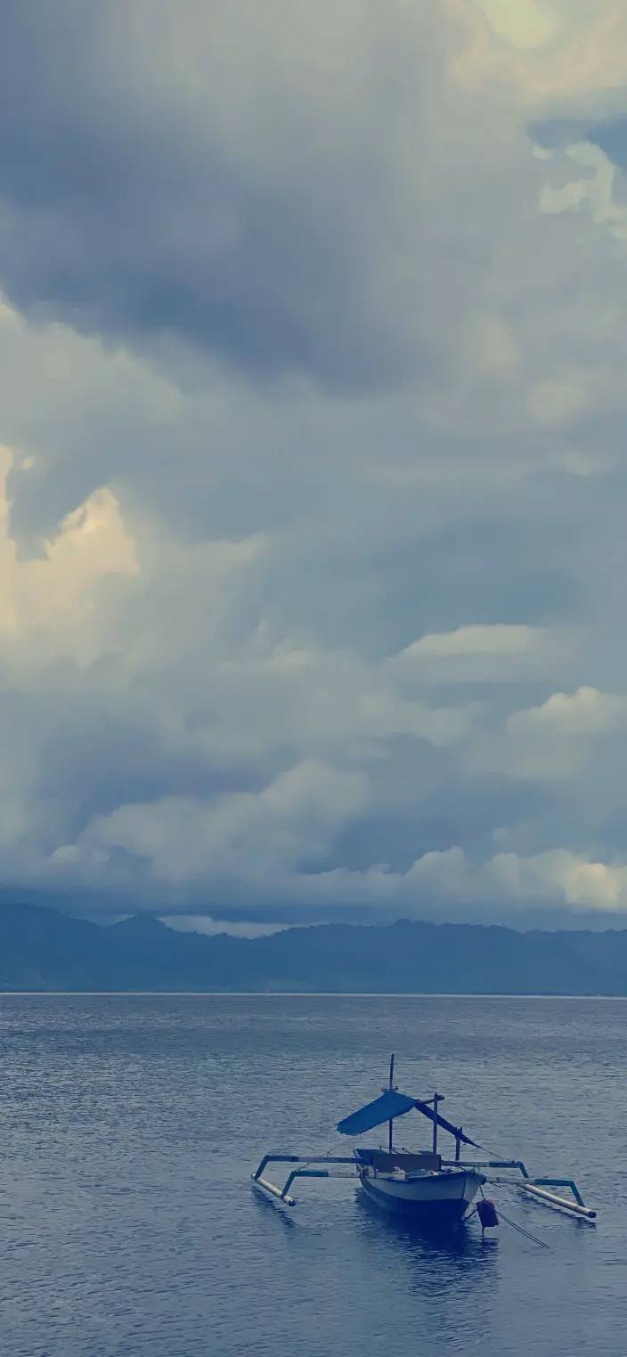 Calm Boat Under Clouds