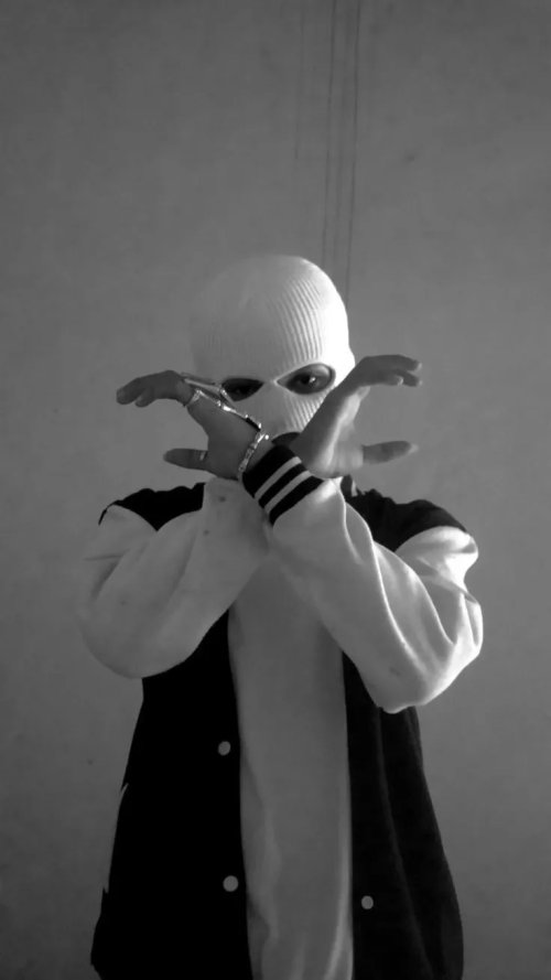 Masked_Figure_in_Handcuffs_Black_and_White