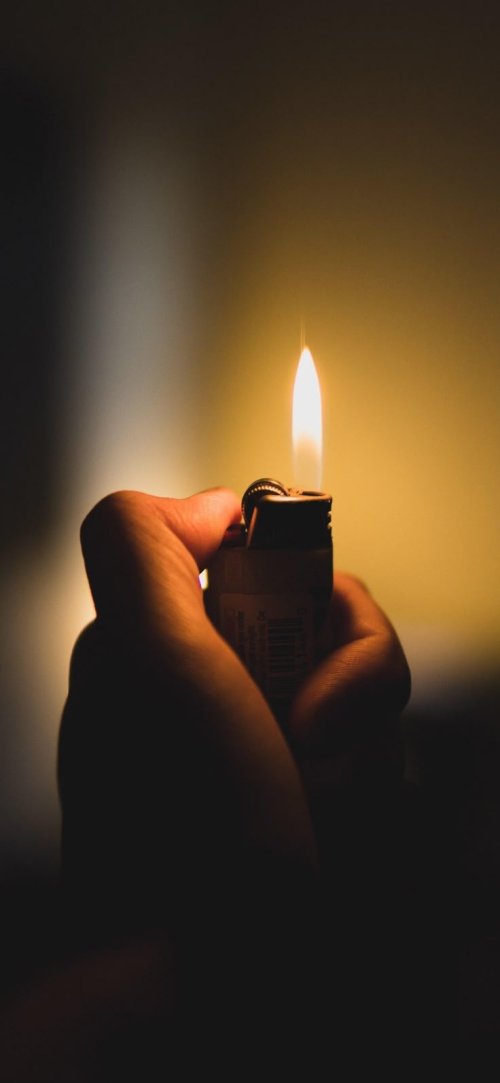Hand Holding Lit Lighter